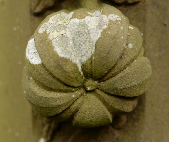 Close-up of a carving of a flower on a grave monument